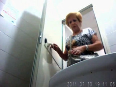 Old lady urinates in hidden camera video clip