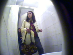 Spy cameras in restroom film girl pissing