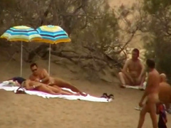 Hubby playing with her pussy in beach voyeur view