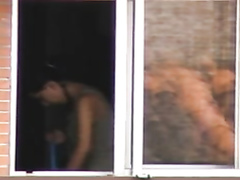 Lovely brunette neighbor changes her clothes at the window