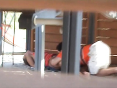 Adults copulating on the playground while filmed