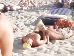 Doing the fellatio on a crowded beach