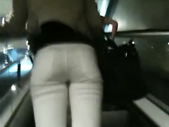 Hot woman's buttocks in thin white jeans