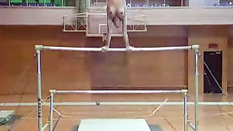 Female gymnast does her routine in bikini bottoms