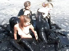 Naked teens play in the dark and messy mud