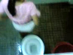 Urinating girl filmed over the bathroom wall