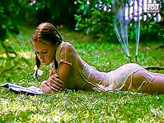 Dominique Swain in wet clothes in the grass