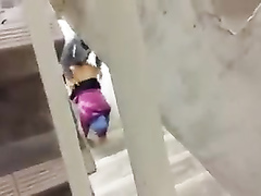 Muslim couple having some fun under the stairs