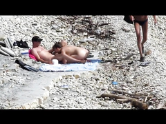 Sensual girl jumps on her boyfriend's fat dick at the nude beach