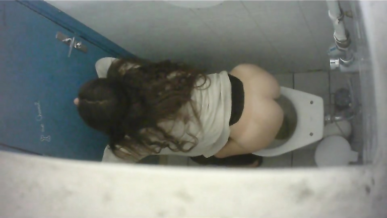 Long-haired brunette with a bubble butt takes a quick pee in the college restroom