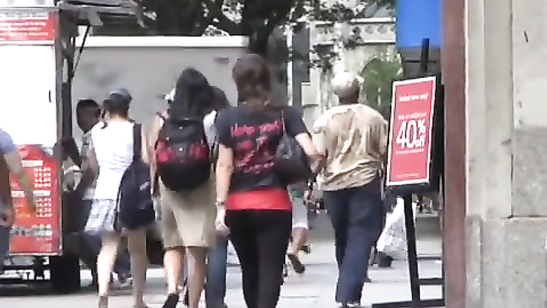 Beautiful girl on the street flirts with a smile