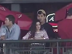 Fondling his cute girlfriend at a baseball game