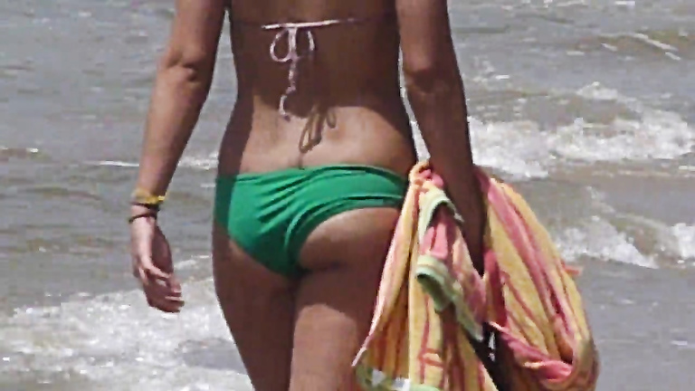 Tanned woman with a nice butt at the beach