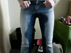 Blue tight jeans get wet with her warm piss