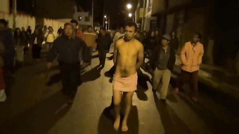 Cops walk a nearly naked criminal down the street